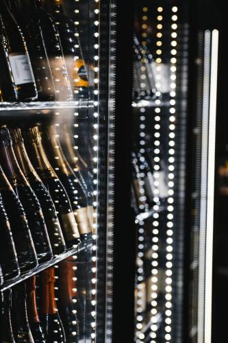 a refrigerator filled with lots of bottles of wine at Hotell Östersund in Östersund