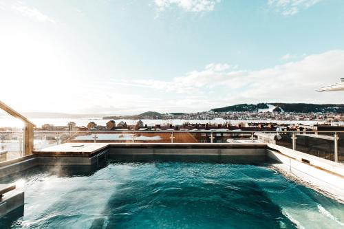 a hot tub on the roof of a building with a view at Hotell Östersund in Östersund