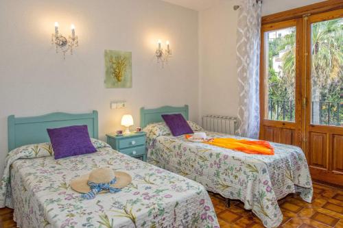 a bedroom with two beds with a hat on them at 0327 Villa El Cau in Jávea