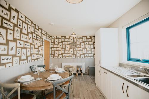 a dining room with a table and chairs and a window at The Seafield Arms Hotel Cullen - Self Catering in Cullen