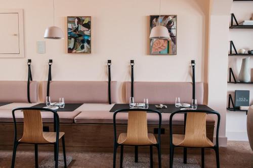 a dining room with two tables and chairs at Port Hotel in Eastbourne