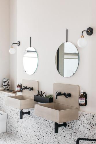 a bathroom with three sinks and a mirror at Port Hotel in Eastbourne