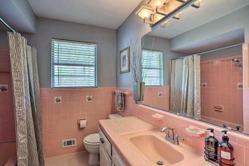 a pink bathroom with a sink and a toilet at 8 Mi to Lake Ray Hubbard Creekside Garland Home in Garland