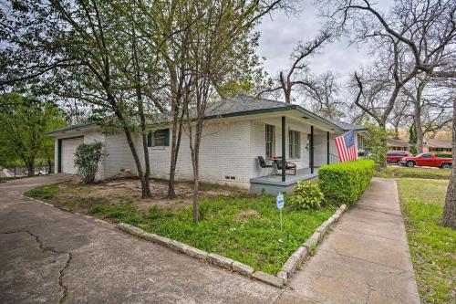 a house with an american flag in front of it at 8 Mi to Lake Ray Hubbard Creekside Garland Home in Garland