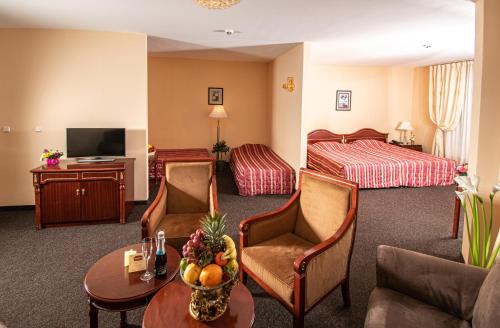 a hotel room with a bed and a living room at Hotel Princess Residence in Kiten
