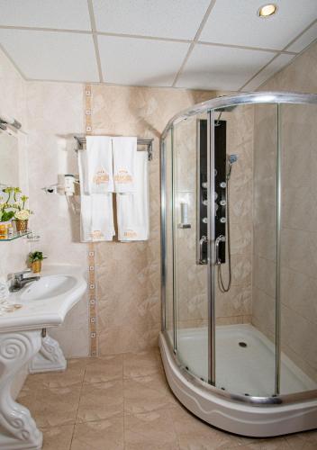 a bathroom with a shower and a sink at Hotel Princess Residence in Kiten