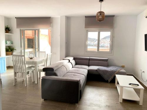 a living room with a couch and a table at Apartamentos El Puerto in San José