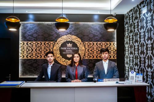 a group of three people sitting at a table at HOTEL PARK VICTORIA in Kolkata