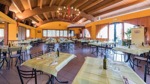 a dining room with tables and chairs and a chandelier at Glamping Florence in Troghi