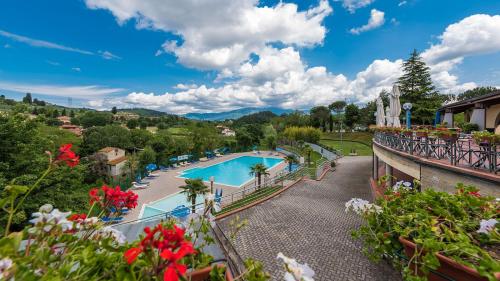 a resort with a swimming pool and flowers at Glamping Florence in Troghi