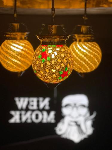 a group of three lights hanging from a ceiling at Hotel Yamuna in Adūr