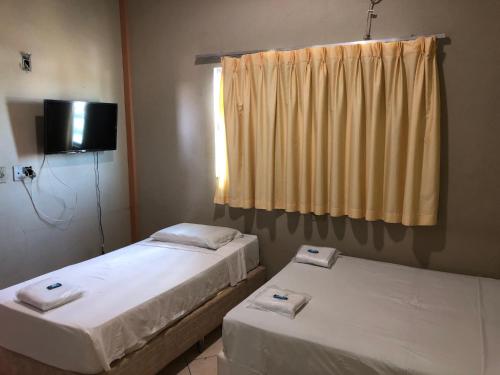 En eller flere senger på et rom på Hotel Graciosa Palace