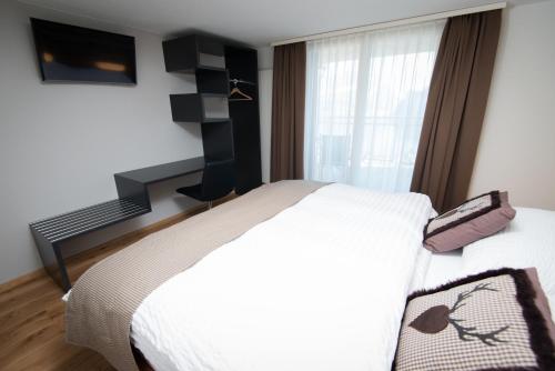 Hotel Roggerliにあるベッド