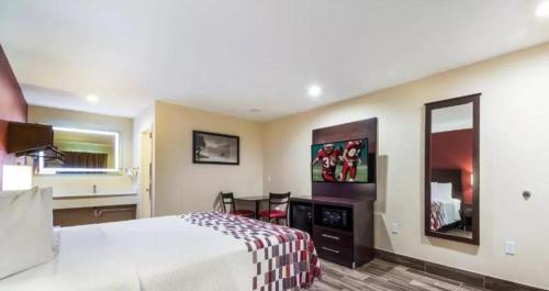a hotel room with a bed and a desk at Ocean's Edge Hotel, Port Aransas,TX in Port Aransas