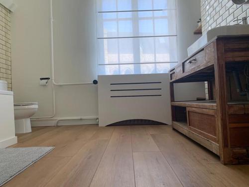 a kitchen with a door and a wooden floor at The westhouse in Middelkerke