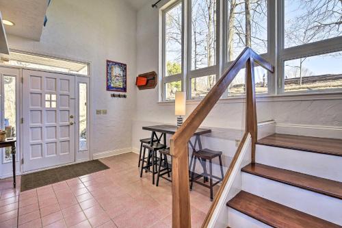 a home with a staircase and a table in a room at Pet-Friendly Cabin with Dock on Claytor Lake! in Radford