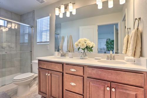 a bathroom with a sink and a toilet and a mirror at Modern Aurora Getaway 22 Mi to Downtown Denver in Watkins