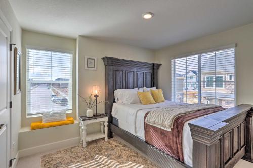 a bedroom with a large bed and two windows at Modern Aurora Getaway 22 Mi to Downtown Denver in Watkins