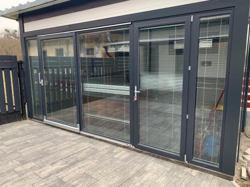 a room with glass doors on a building at Filkes Rezidence in Filkeháza