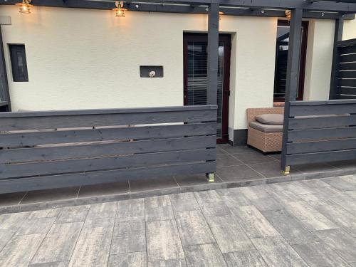 a pair of benches in front of a building at Filkes Rezidence in Filkeháza