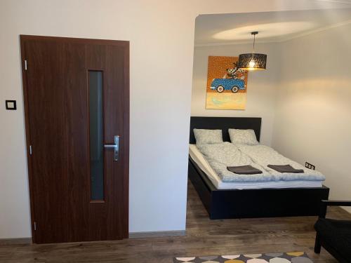 a bedroom with a bed next to a door at Filkes Rezidence in Filkeháza