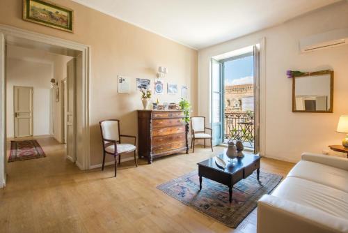 a living room with a couch and a table at Cathedral View Apartments in Palermo