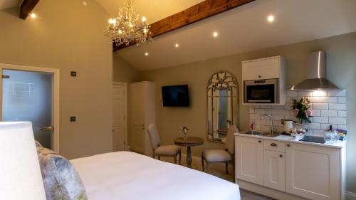 a bedroom with a bed and a kitchen with a table at The Hotel Chester in Chester