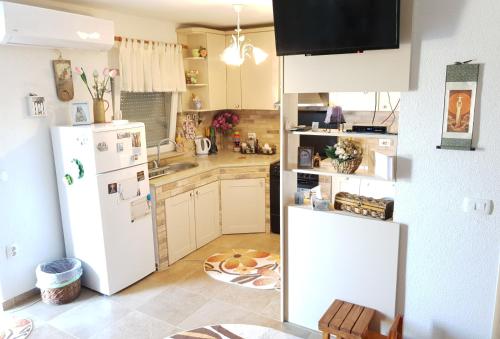 a kitchen with a white refrigerator and a sink at DELIA in Međugorje