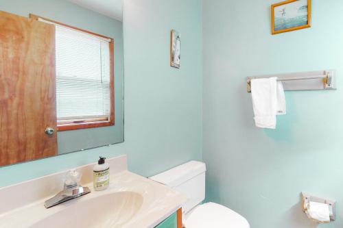 a bathroom with a sink and a toilet and a mirror at Red Rover #19-F in Frisco