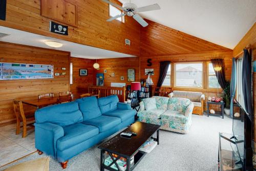 a living room with a blue couch and a table at Red Rover #19-F in Frisco