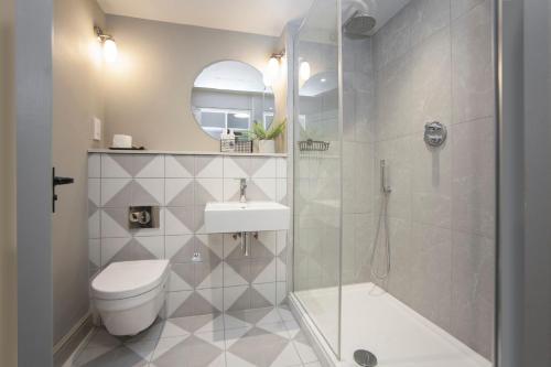 a bathroom with a shower and a toilet and a sink at The King's Arms in Dorchester