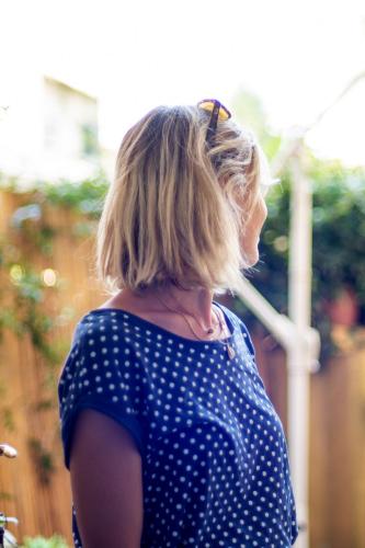 a woman in a blue and white polka dot shirt at La Lu cozy rooms 2 in Pisa
