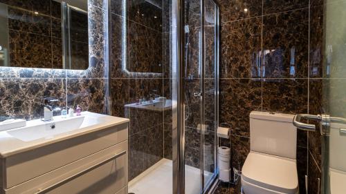a bathroom with a shower and a sink and a toilet at The Hotel Chester in Chester