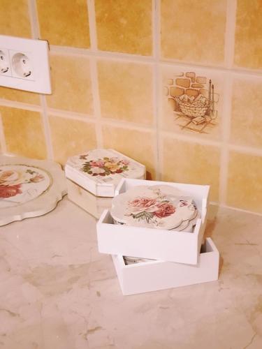 three boxes of plates on the floor in a bathroom at DELIA in Međugorje