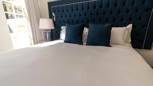 a bedroom with a large bed with blue pillows at The Hotel Chester in Chester