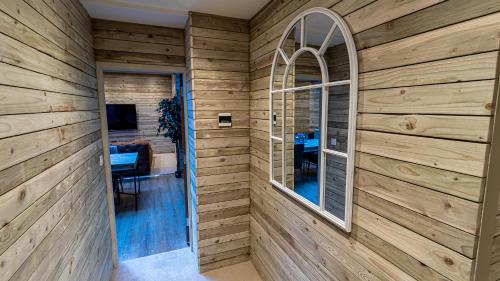 a room with wood paneled walls and a window at The Hotel Chester in Chester