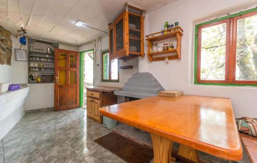 a kitchen with a wooden table in a room at House Tvrdica in Tkon