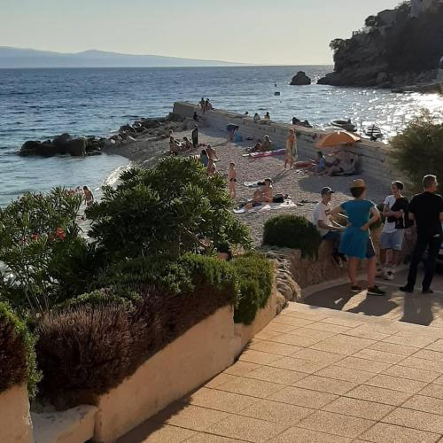 a group of people on a beach near the water at 5 stars 2 bedrooms villa BLUE DREAM village Pisak Croatia in Pisak