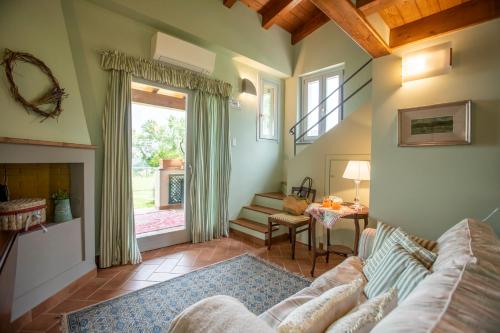 a living room with a couch and a window at L'Olivo Country Resort & SPA in Bassano in Teverina