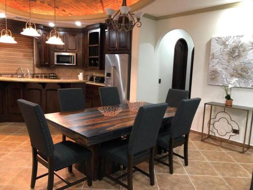 a kitchen and dining room with a wooden table and chairs at ESMERALDA B-201 in Puerto Peñasco