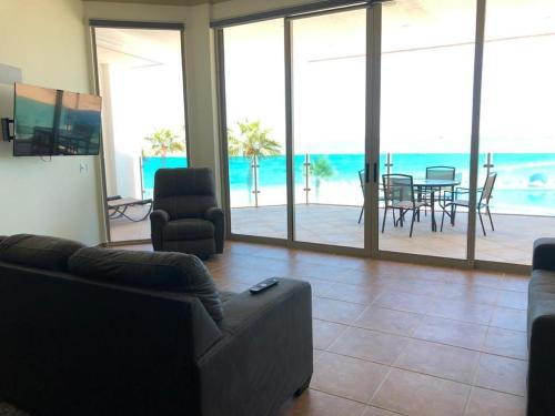 a living room with couches and a view of the ocean at ESMERALDA B-201 in Puerto Peñasco