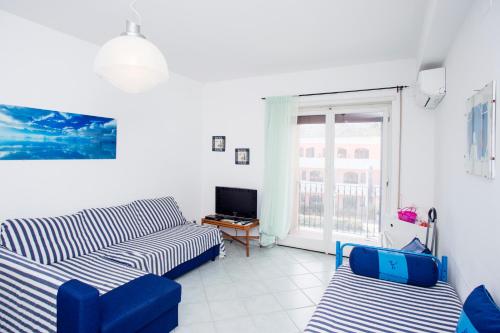 a living room with two couches and a television at Casa Malu in Marina di Campo