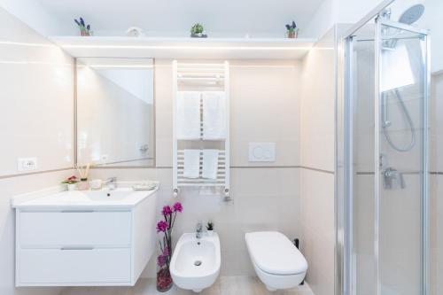 a bathroom with a sink and a toilet and a shower at Charming House in Amalfi