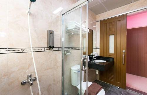 a bathroom with a shower and a toilet and a sink at 花蓮童樂會親子民宿 in Zhixue