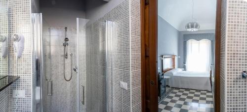 a bathroom with a shower and a toilet and a sink at Dimora La Torre Room in Favignana