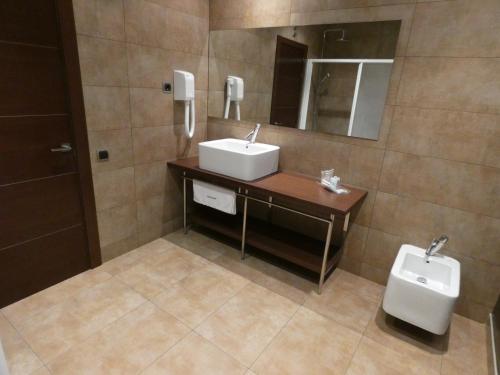 a bathroom with a sink and a toilet at Fuente del Miro in Valderrobres