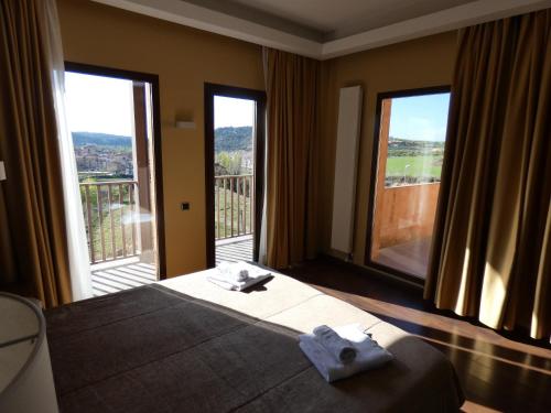 a bedroom with a bed with two towels on it at Fuente del Miro in Valderrobres