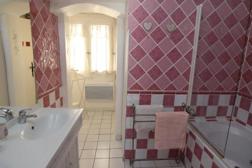 a bathroom with a tub and a sink and a shower at Le Mas Fraissinet in Saint-Jean-de-Valériscle