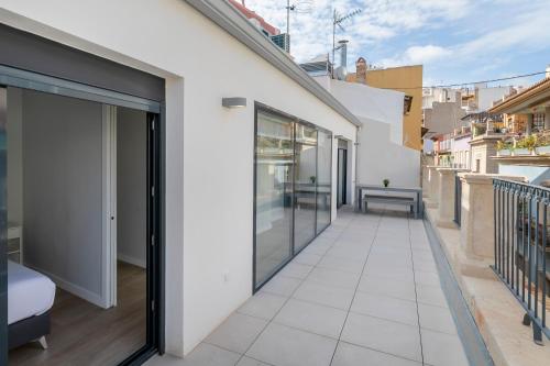 a balcony with sliding doors and a view of a building at Arenal Suites Alicante in Alicante