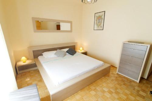 a bedroom with a bed and a dresser and a mirror at Old Town Budget in Dubrovnik